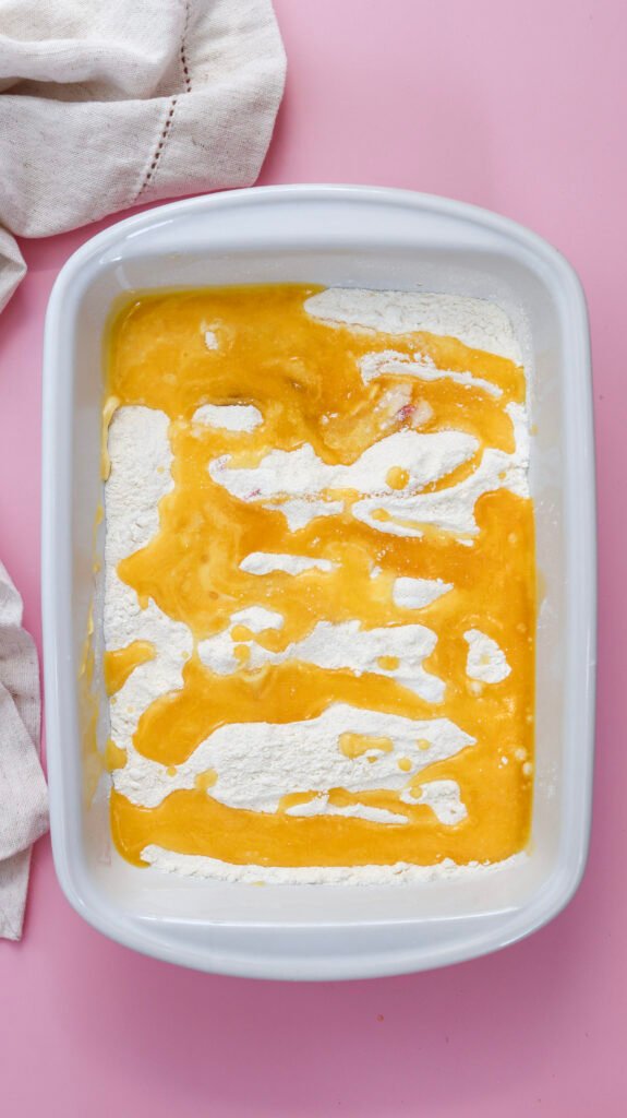drizzling melted butter on the cake mix