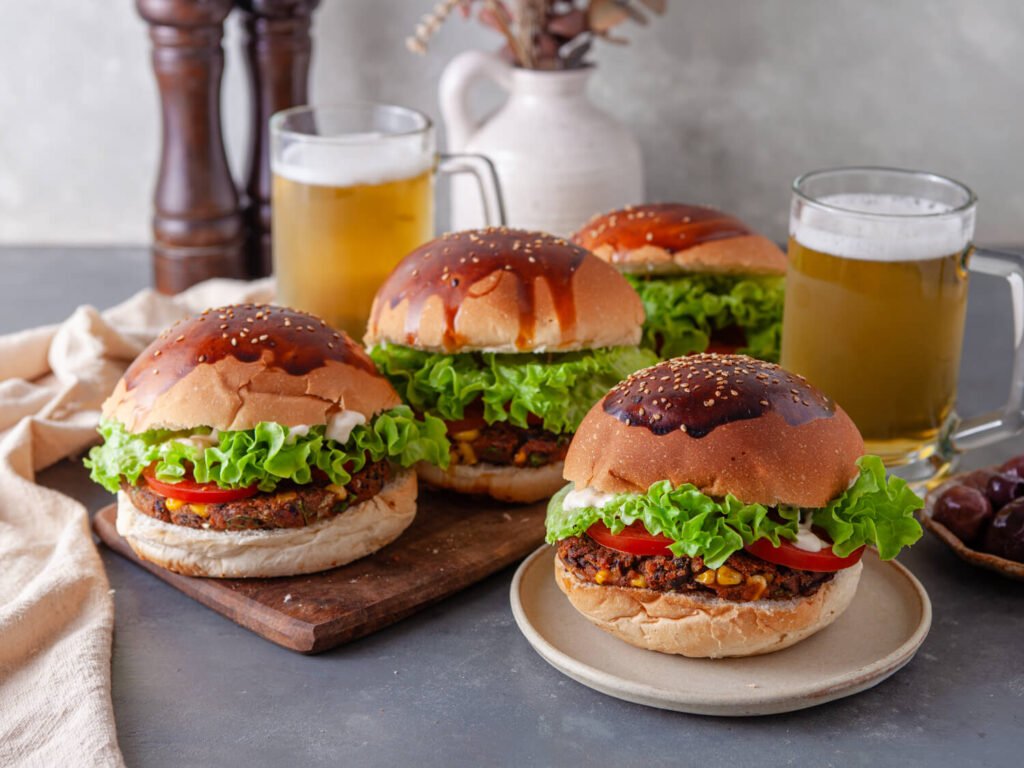 Four black bean veggie burgers on a table