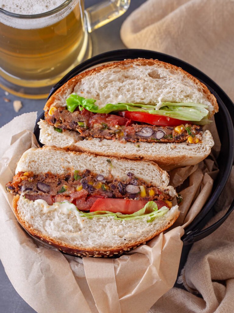 A black bean veggie burger cut in half to show the inside, revealing its delicious layers