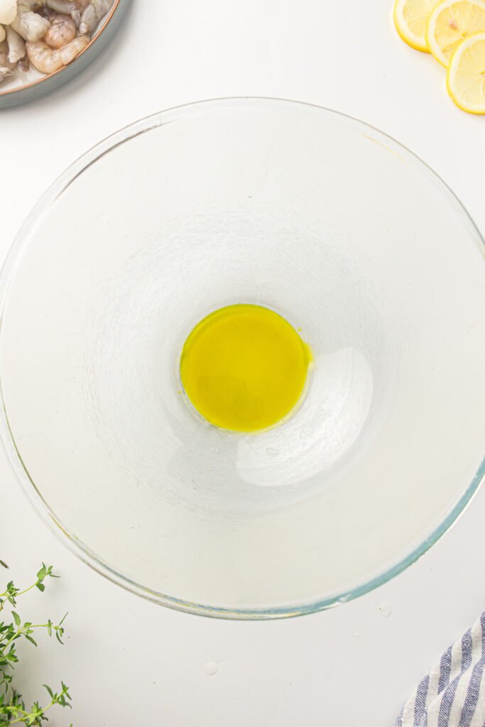 A glass bowl with avocado oil at the bottom