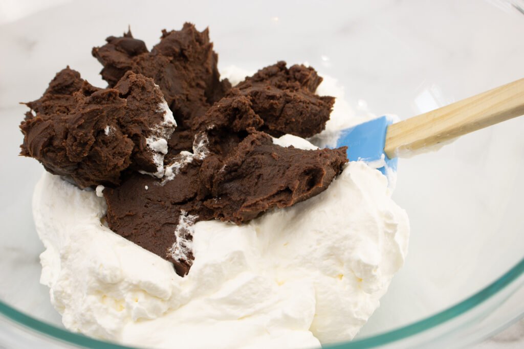 fold the chilled chocolate into the whipped cream to make chocolate mousse