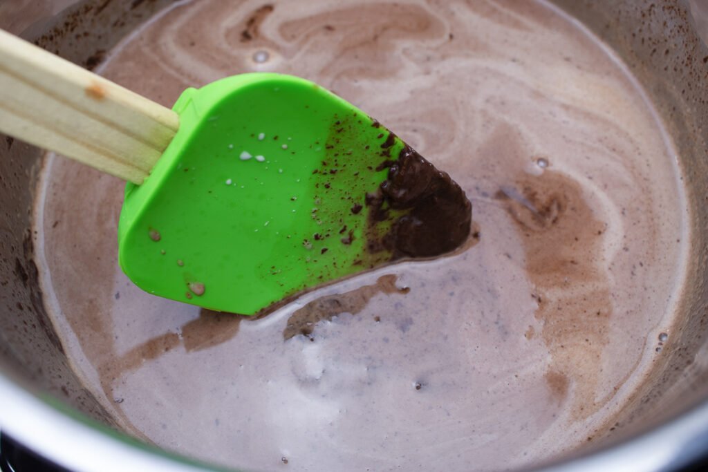 mixing the chocolate chips and heavy cream until melted