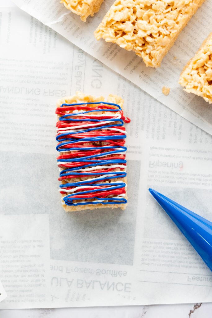 4th of July Rice Krispie treat decorated with red, white, and blue drizzle