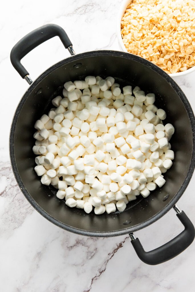 Mini marshmallows added to a large pot with melted butter