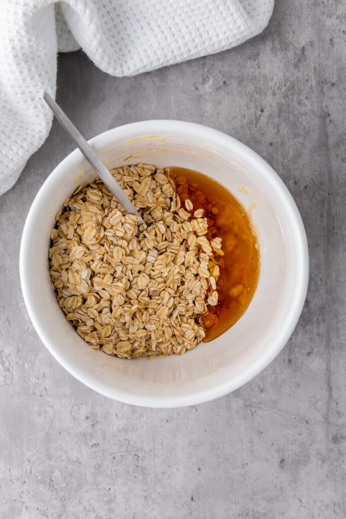 mashed banana with oats and honey in a white bowl