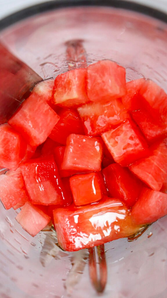 Cubed watermelon with honey in a blender, ready to blend