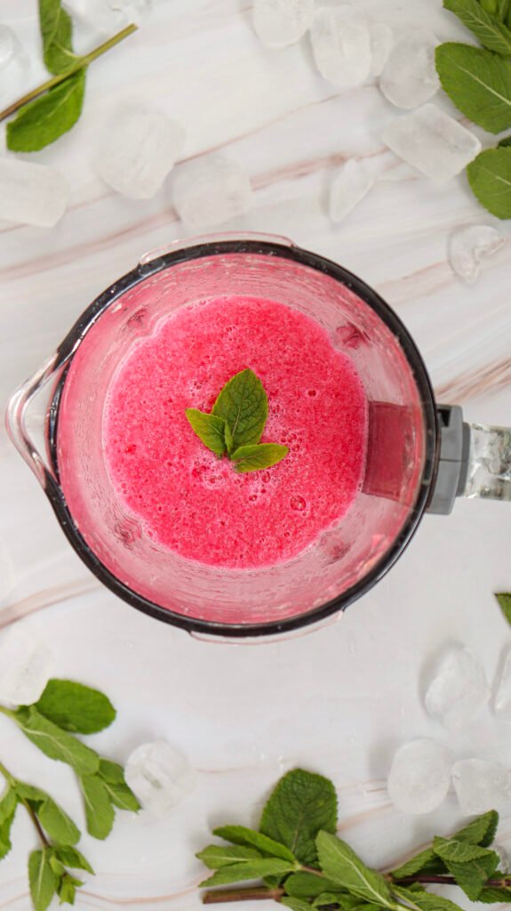 watermelon slushie in a blender, topped with mint