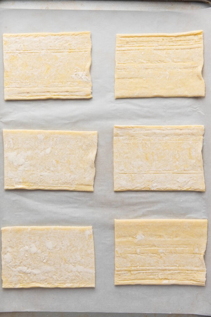 Puff pastry cut into six even rectangles on parchment paper