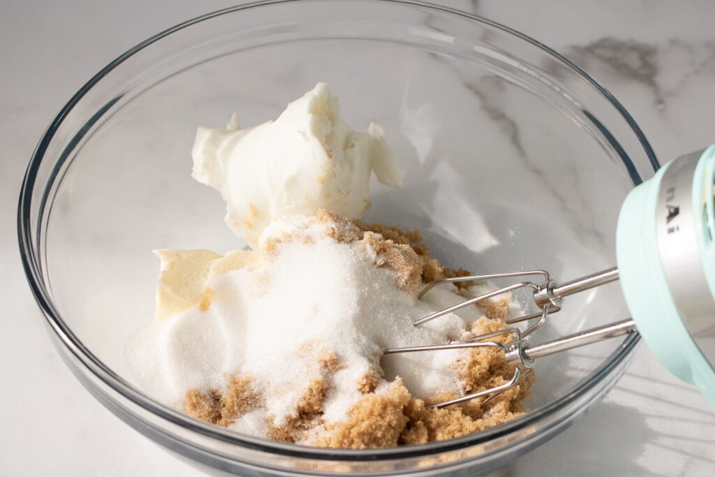 Butter, shortening, and both sugars in a mixing bowl, ready to be blended with a hand mixer