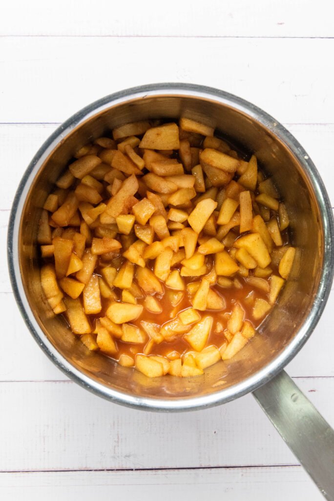Apple filling simmered in a saucepan with cinnamon and sugar