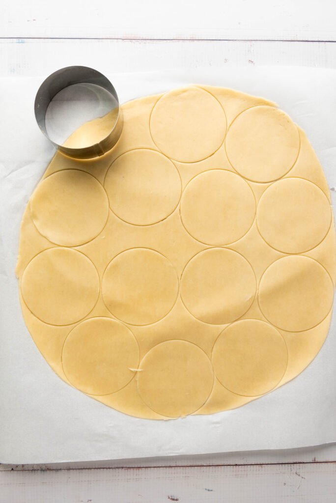 Pie dough with multiple circles cut out using a round cutter