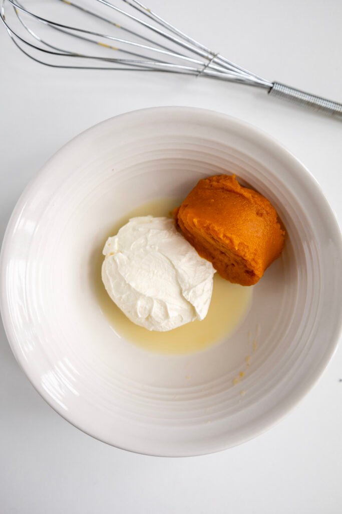Pumpkin puree, cream cheese, and milk ready to be mixed for frosting