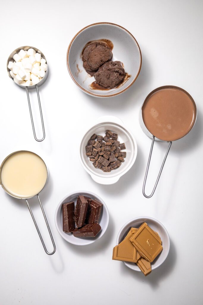 Measured ingredients for a chocolate freakshake on a white background
