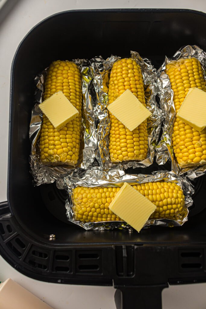 Air Fryer Sweetcorn on the Cob putting in the air fryer