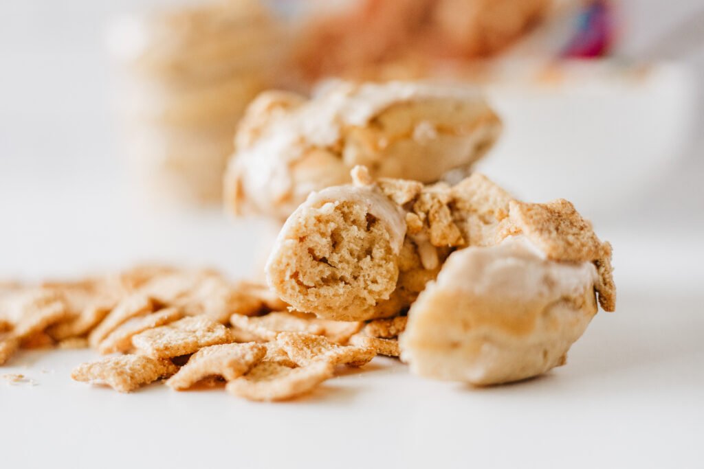 Close-up of a Cinnamon Toast Crunch Donut broken in half to show its soft, fluffy inside